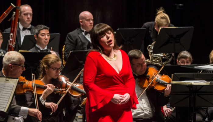 woman signing in front of the Springfield Symphony